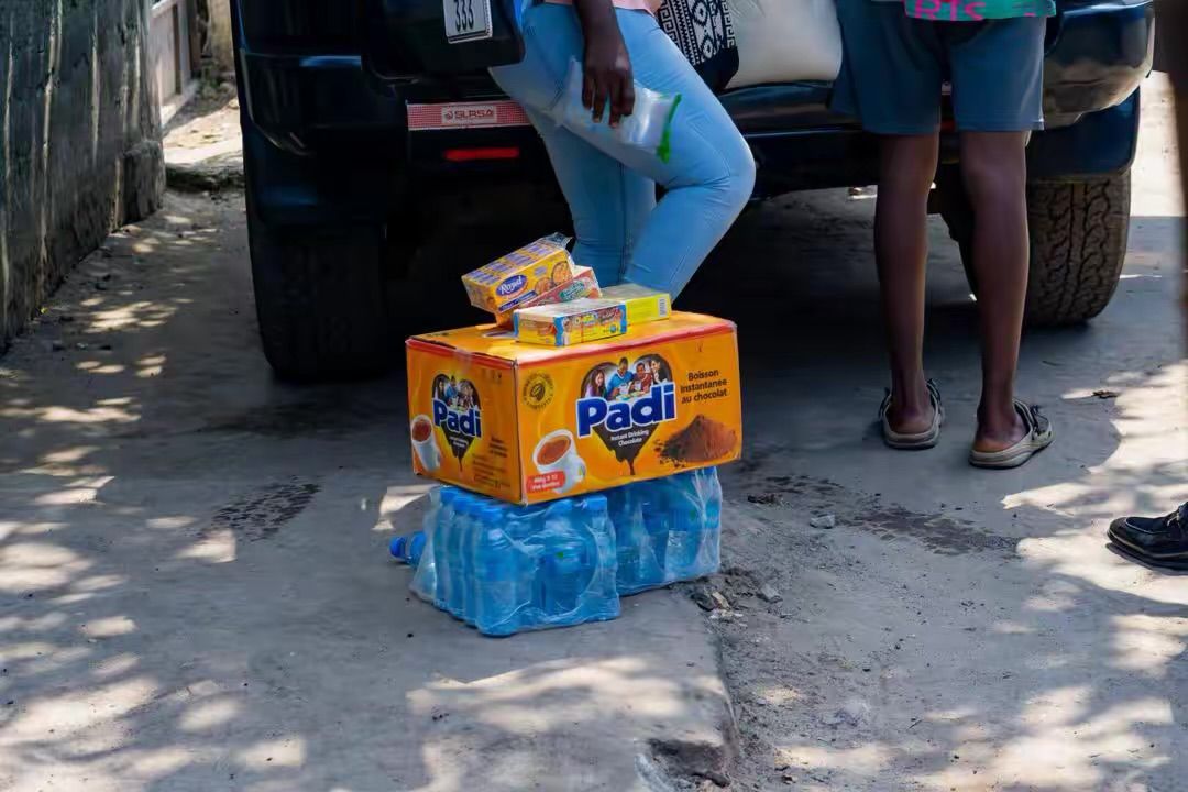 Drinks and supplies being unloaded from a car