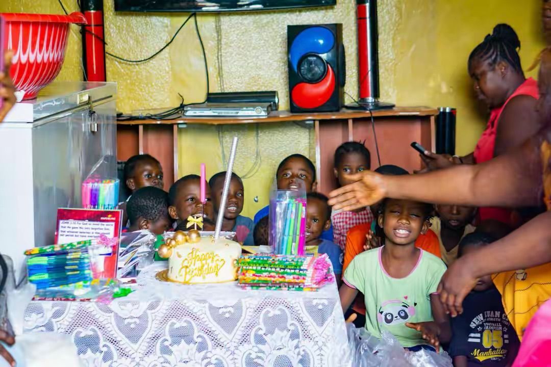Children smiling around a birthday table
